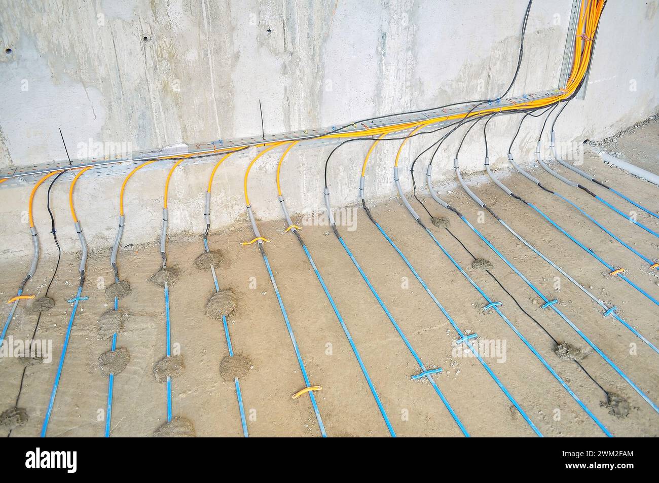 Construction site: cable laying on concrete for warm floor Stock Photo ...