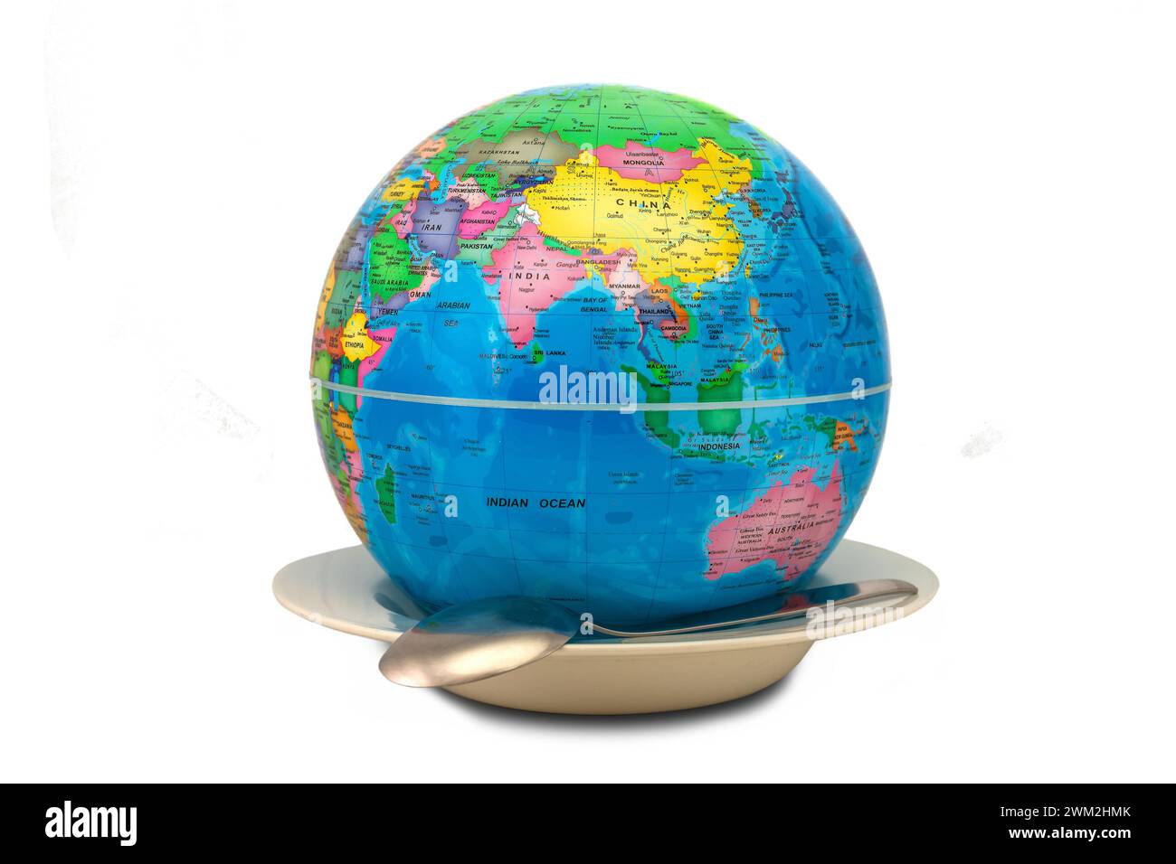 World globe inside an empty plate showing Asia and Australia - world hunger concept. The empty plate symbolizes the lack of food. Stock Photo