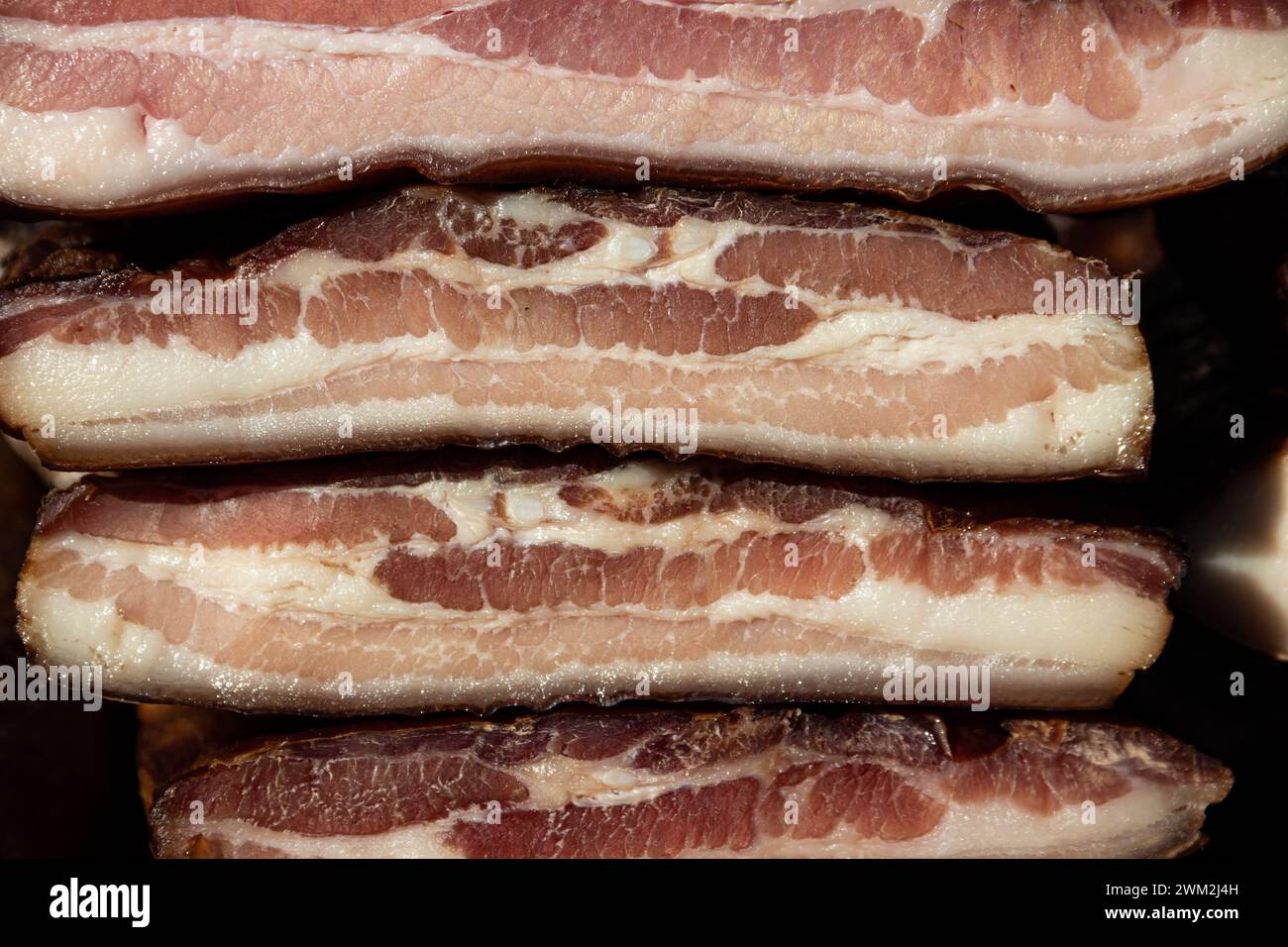 Exposed bacon and dried meat domestic products presented for sale on a farmer's market in Kacarevo village,gastro bacon and dry meat products festival Stock Photo