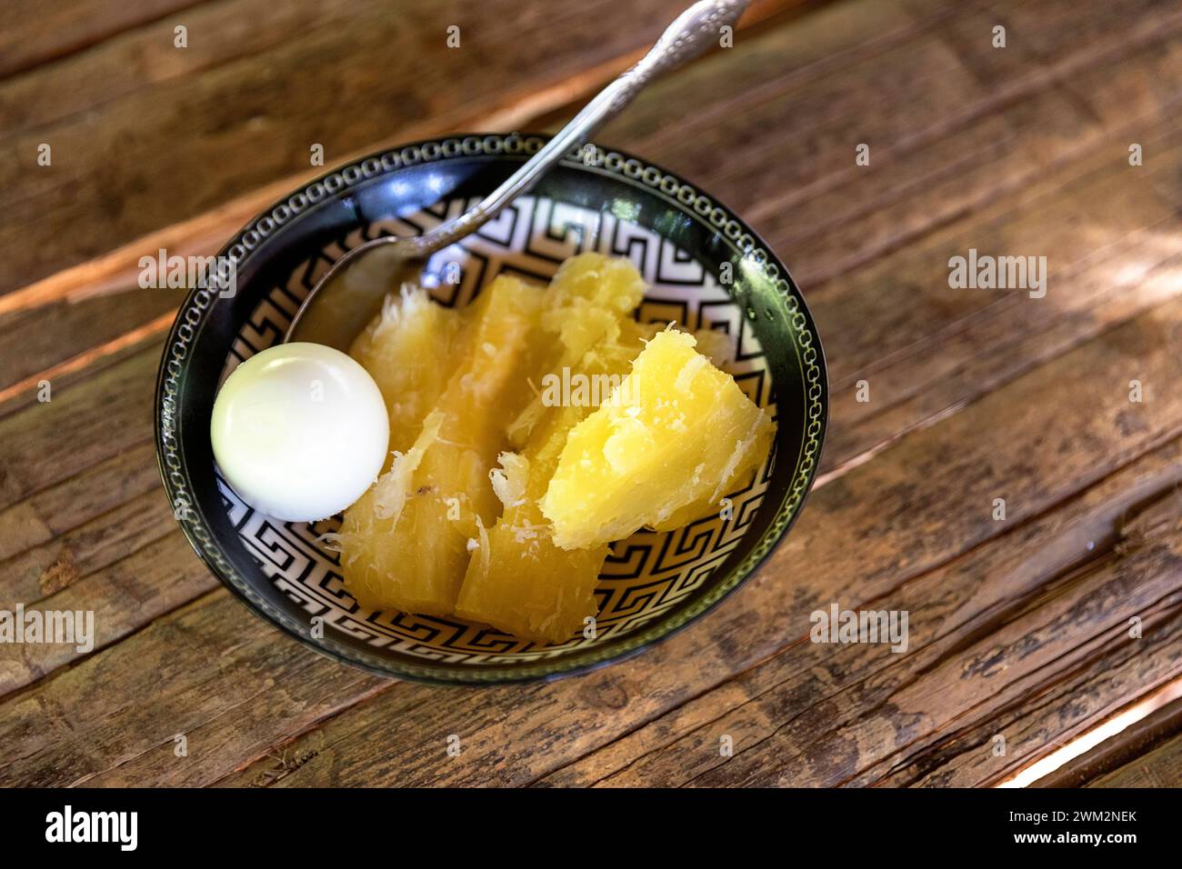Cooked yuca with an egg for breakfast in Embera village, Chagres National park, Panama Stock Photo
