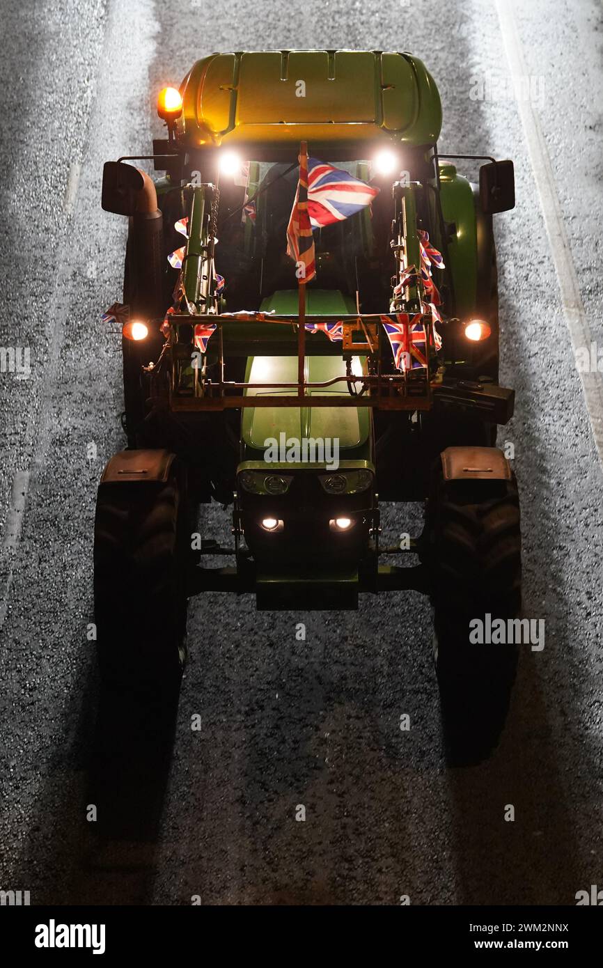 Farmers driving their tractors in a convoy in Ashford, Kent to protest against cheap meat imports. Picture date: Friday February 23, 2024. Stock Photo