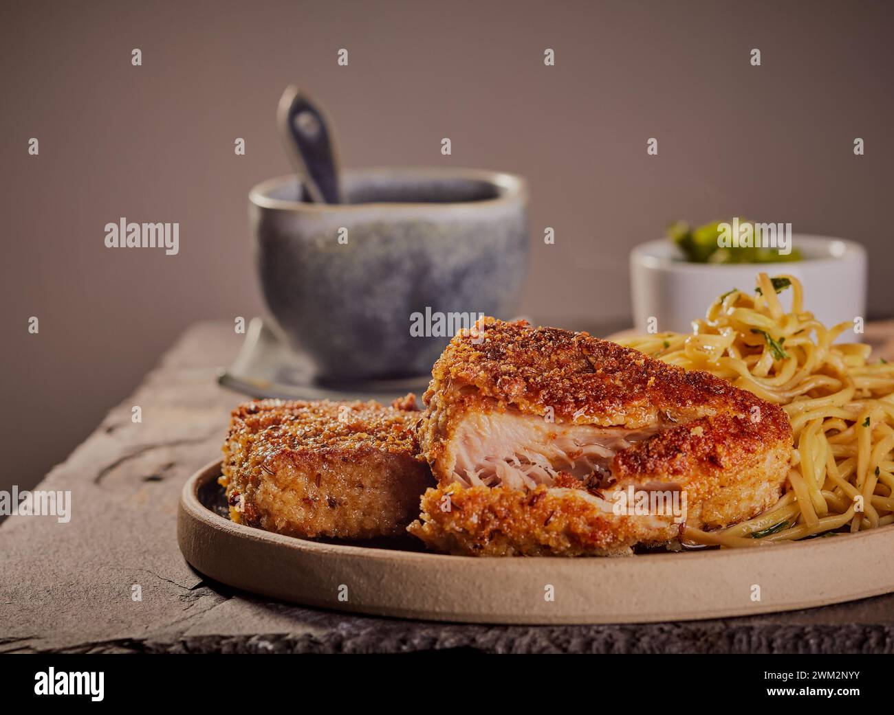 Breaded tuna steaks with tarragon noodles Stock Photo Alamy