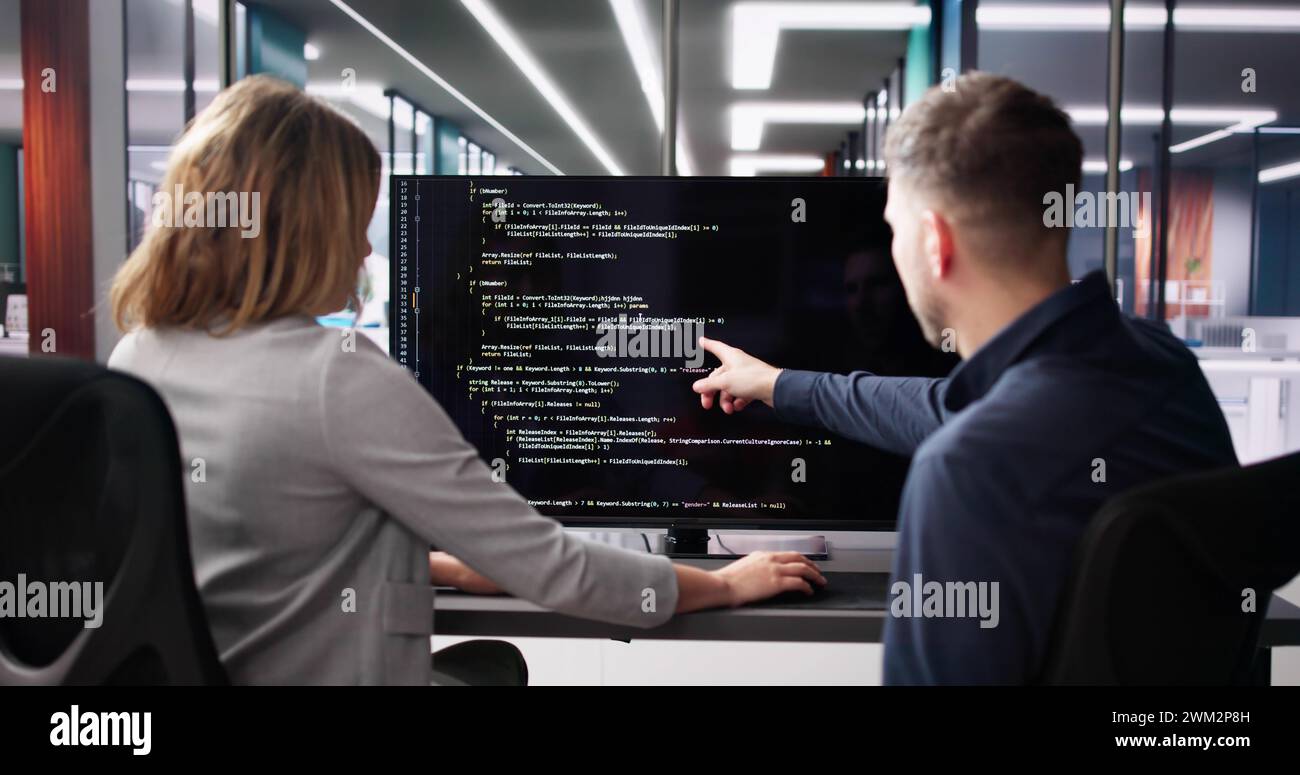 Computer Programmer Using Development Software On Laptop Stock Photo