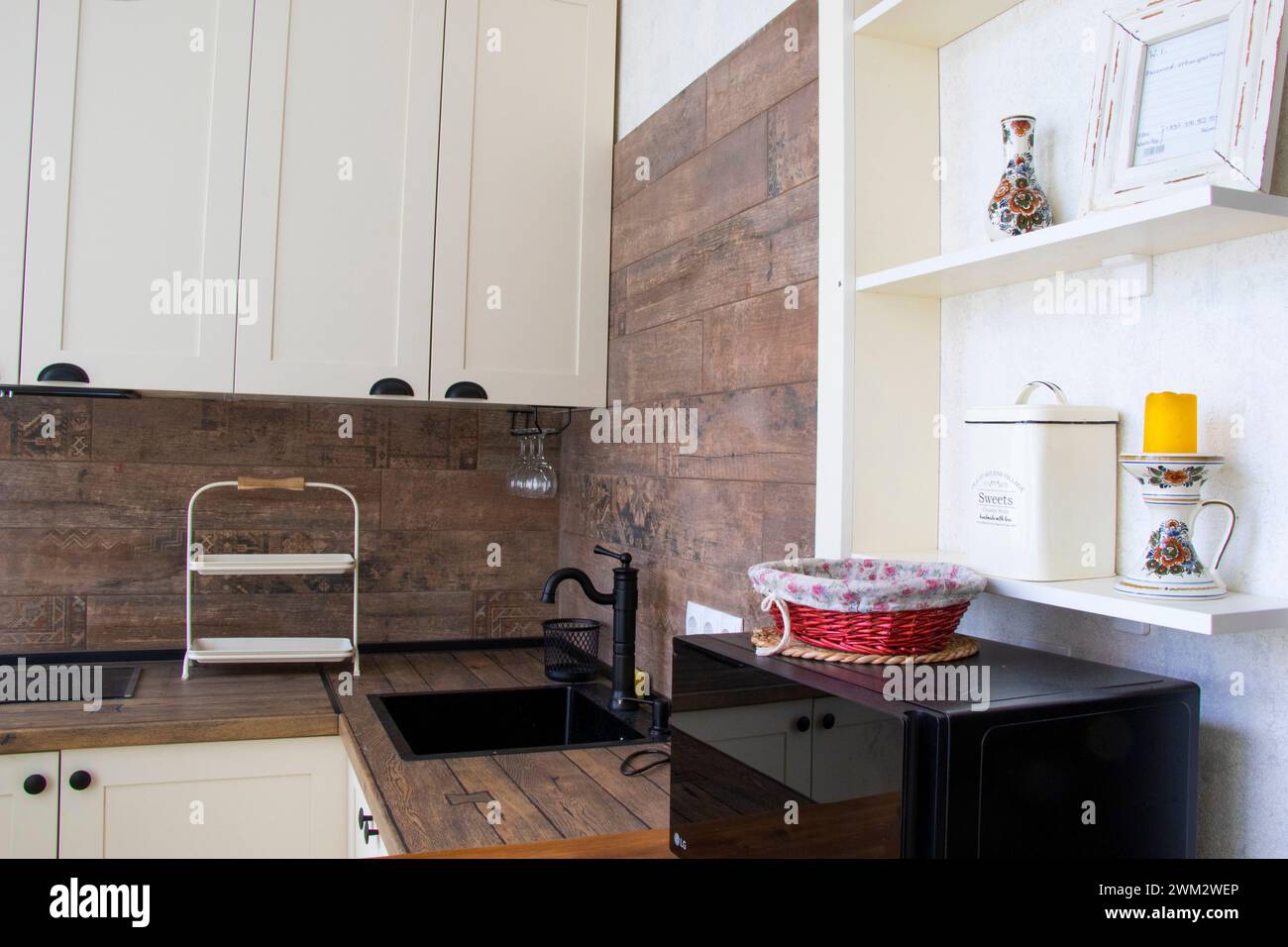Kitchen sink with wooden counter and cabinets Stock Photo - Alamy