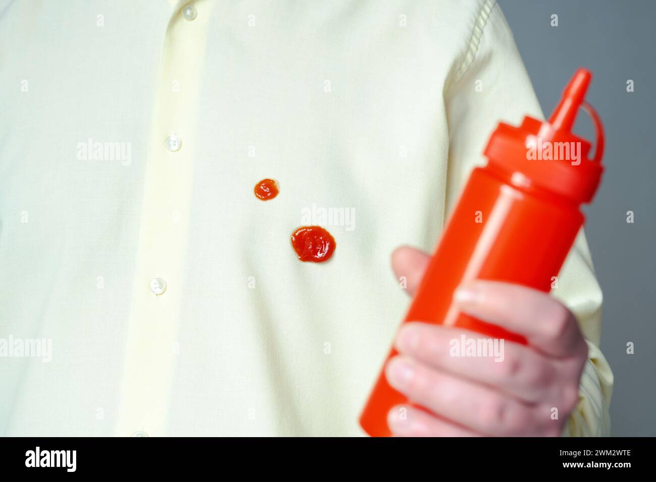 Spilled tomato sauce or ketchup on clothes. Food preparation process