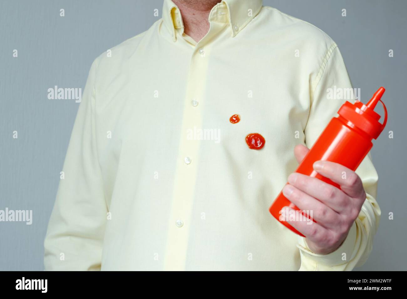 Spilled tomato sauce or ketchup on clothes. Food preparation process