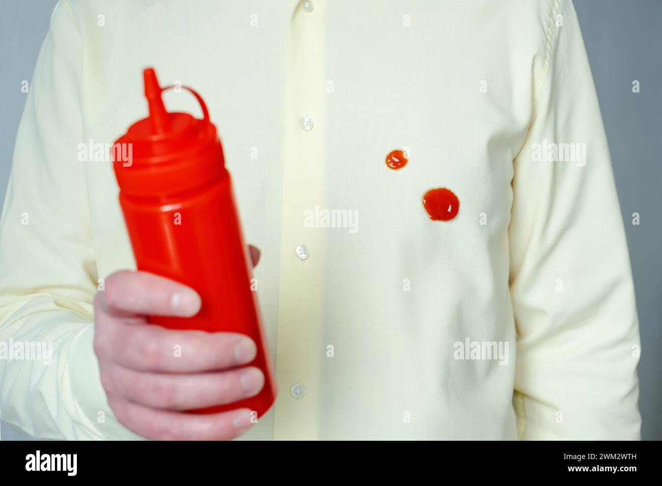 Spilled tomato sauce or ketchup on clothes. Food preparation process