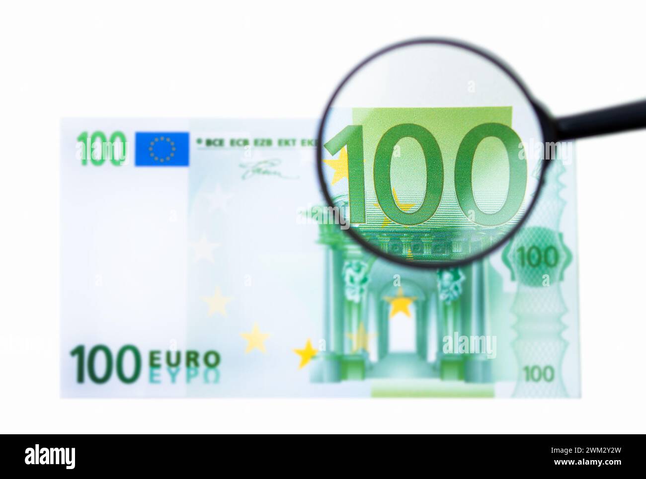Hundred euro bill and magnifying glass isolated on white Stock Photo ...