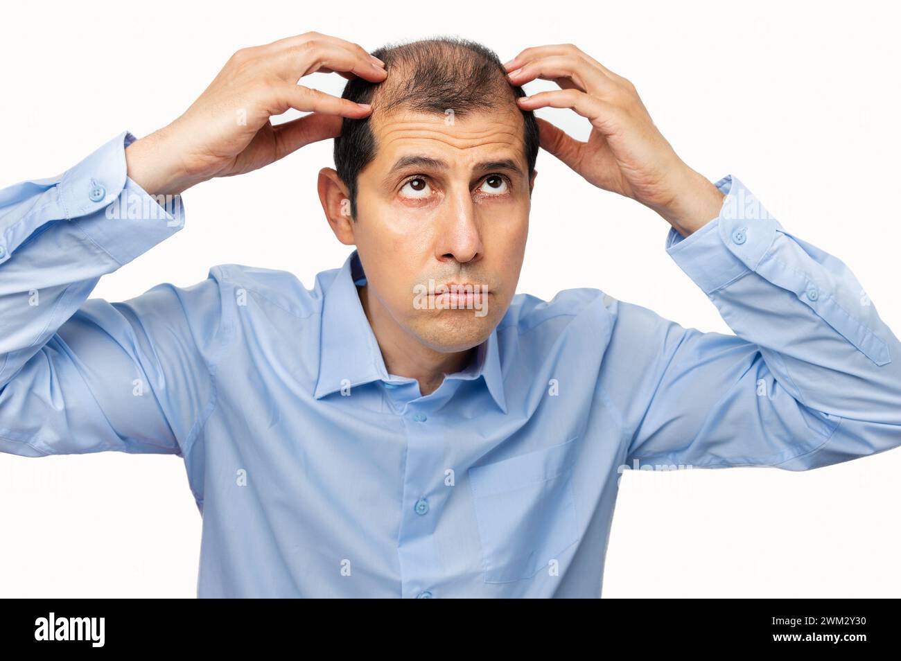 man controls hair loss with white background Stock Photo