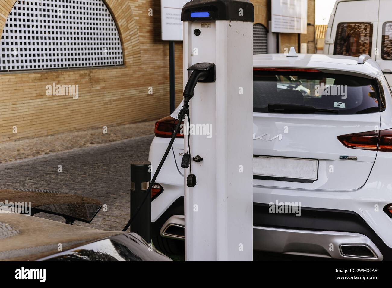 Electric car charging at a public electric car charger. Mérida, Badajoz, Extremadura, Spain, Europe Stock Photo
