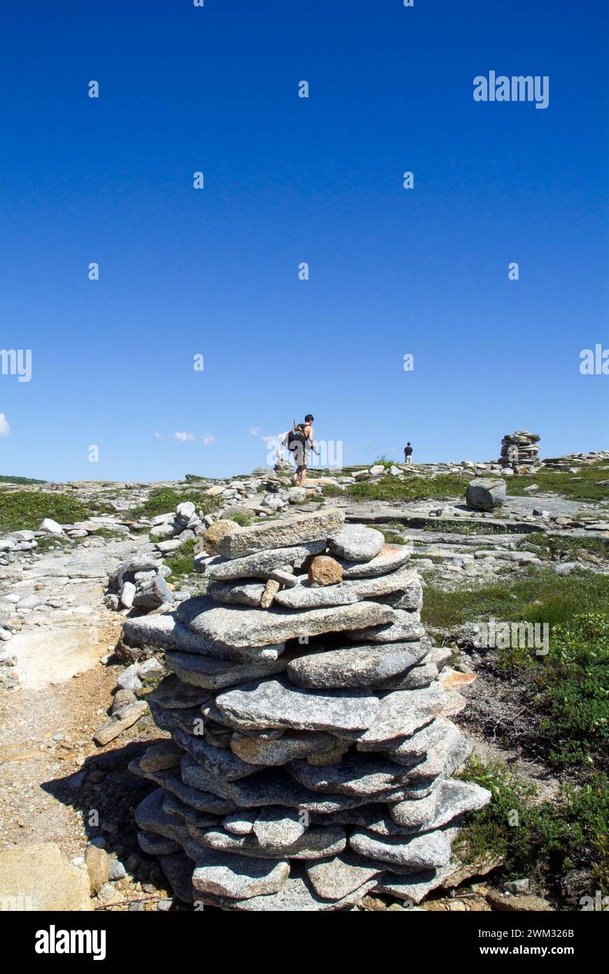 Hikers on  Baldface Knob Trail in the scenic landscape of the White Mountains, New Hampshire USA during the spring months. Stock Photo