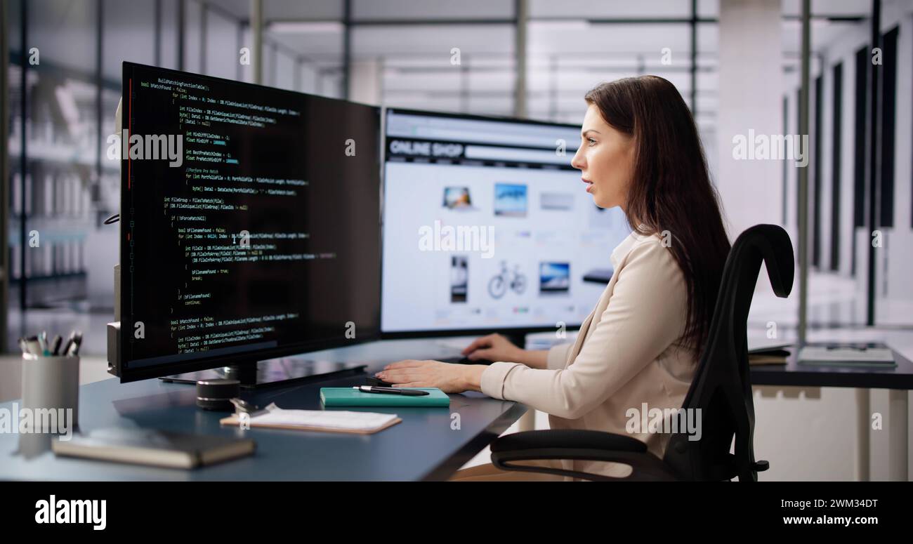 Coder Using Computer At Desk. Web Developer Stock Photo