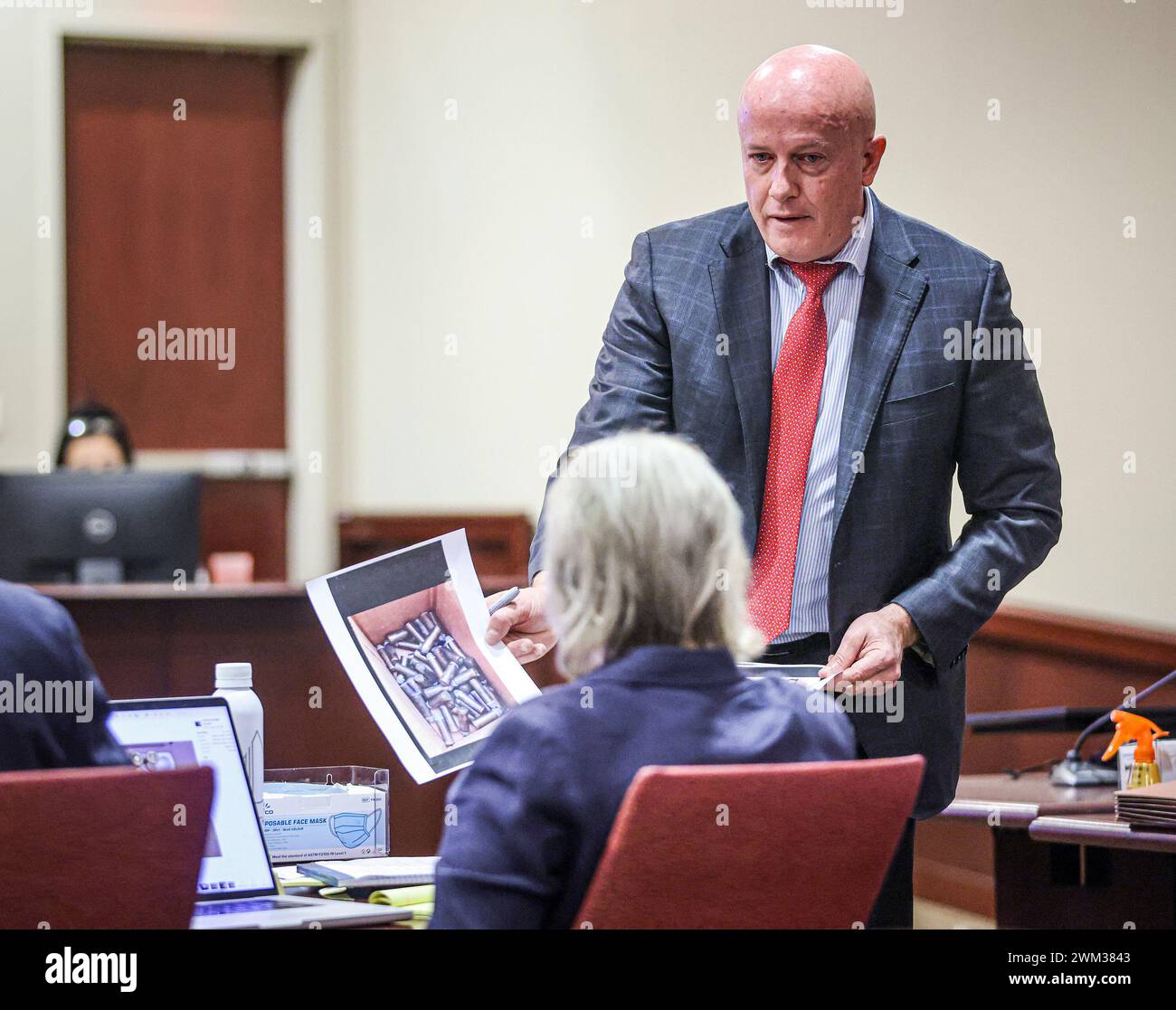 Defense attorney Jason Bowles shows special prosecutor Kari Morrissey a