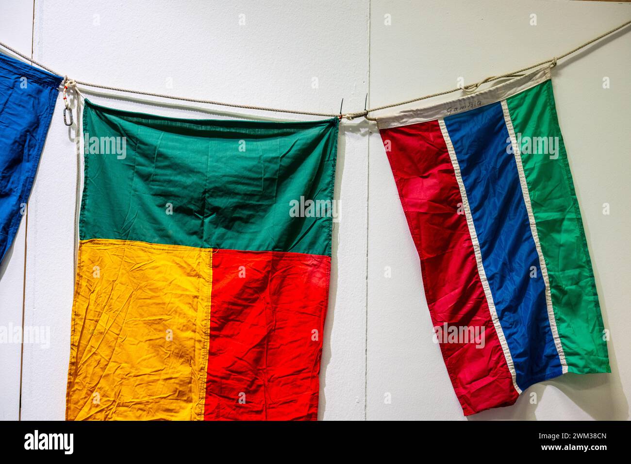 Wrinkled flags of Bening and Gambia on a wall Stock Photo - Alamy