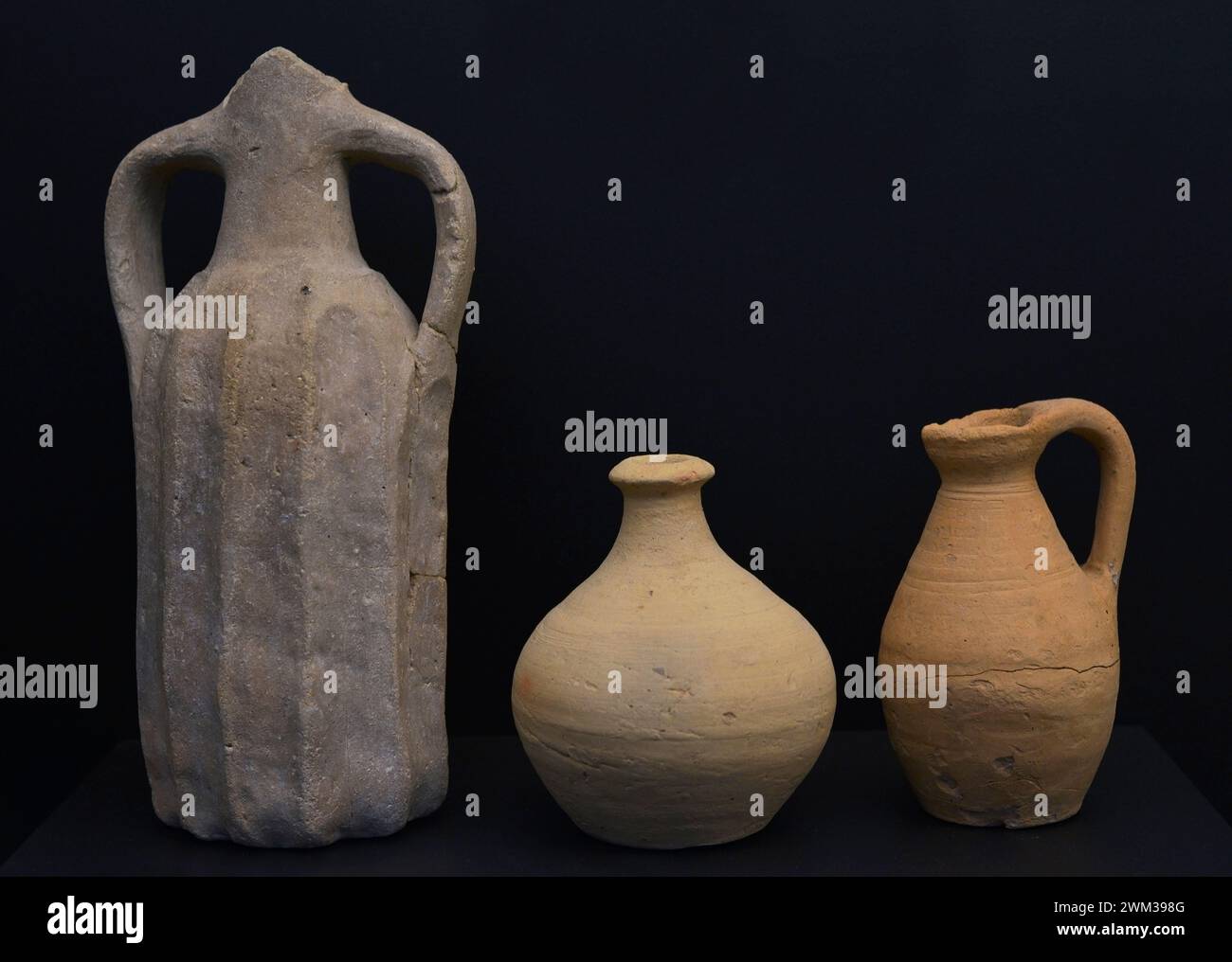 Pottery. From left to right: jug with cylindrical and ribbed body, 8th-9th centuries, from Toledo's Vega Baja archaeological site; globular-bodied bottle, 4th-5th centuries, from the Roman villa of Carranque (province of Toledo), bitronconical jug handled, 7th century, unknown provenance. Museum of Visigoth Councils and Culture. Toledo, Castile-La Mancha, Spain. Stock Photo