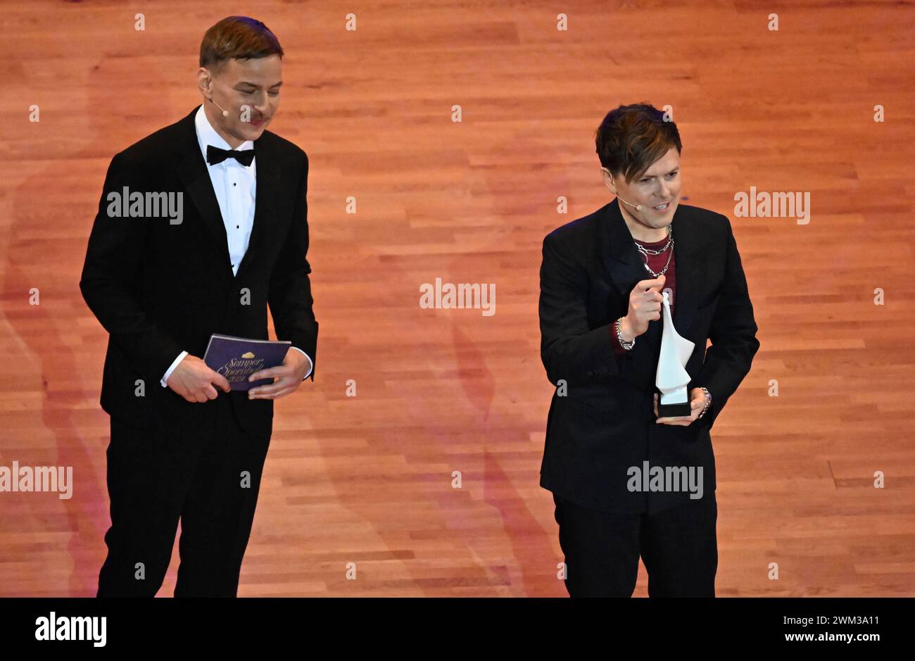 Dresden, Germany. 23rd Feb, 2024. Actor and presenter Tom Wlaschiha (l) presents the Choros Award for social commitment to singer Michael Patrick Kelly at the 16th Dresden Semper Opera Ball in the Semperoper. Credit: Sebastian Kahnert/dpa/Alamy Live News Stock Photo