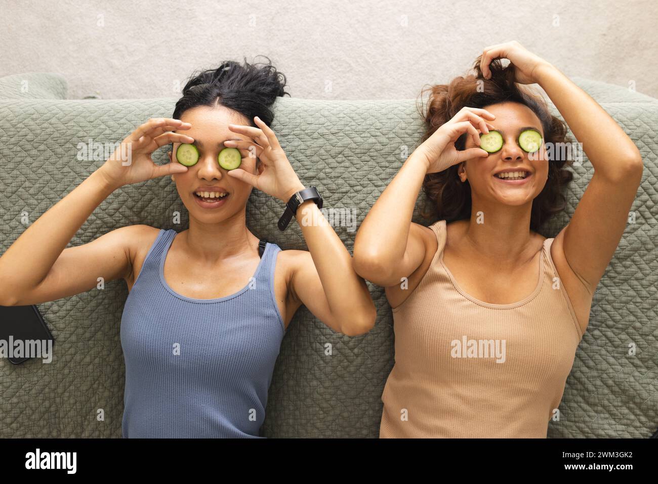 Biracial female friends enjoy a spa day at home Stock Photo
