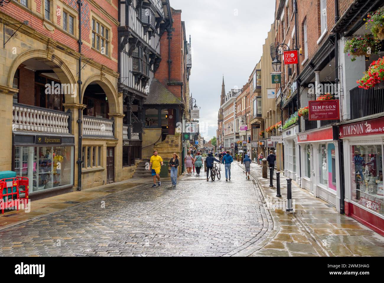 Chester, England - July 09, 2023: People walking along Watergate Street after a summer thunderstorm Stock Photo