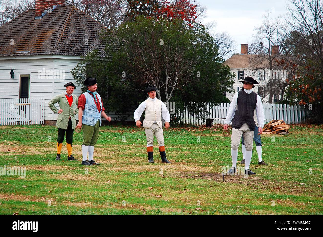 Costumed reenactors in Williamsburg participate in a colonial American pastime game Stock Photo