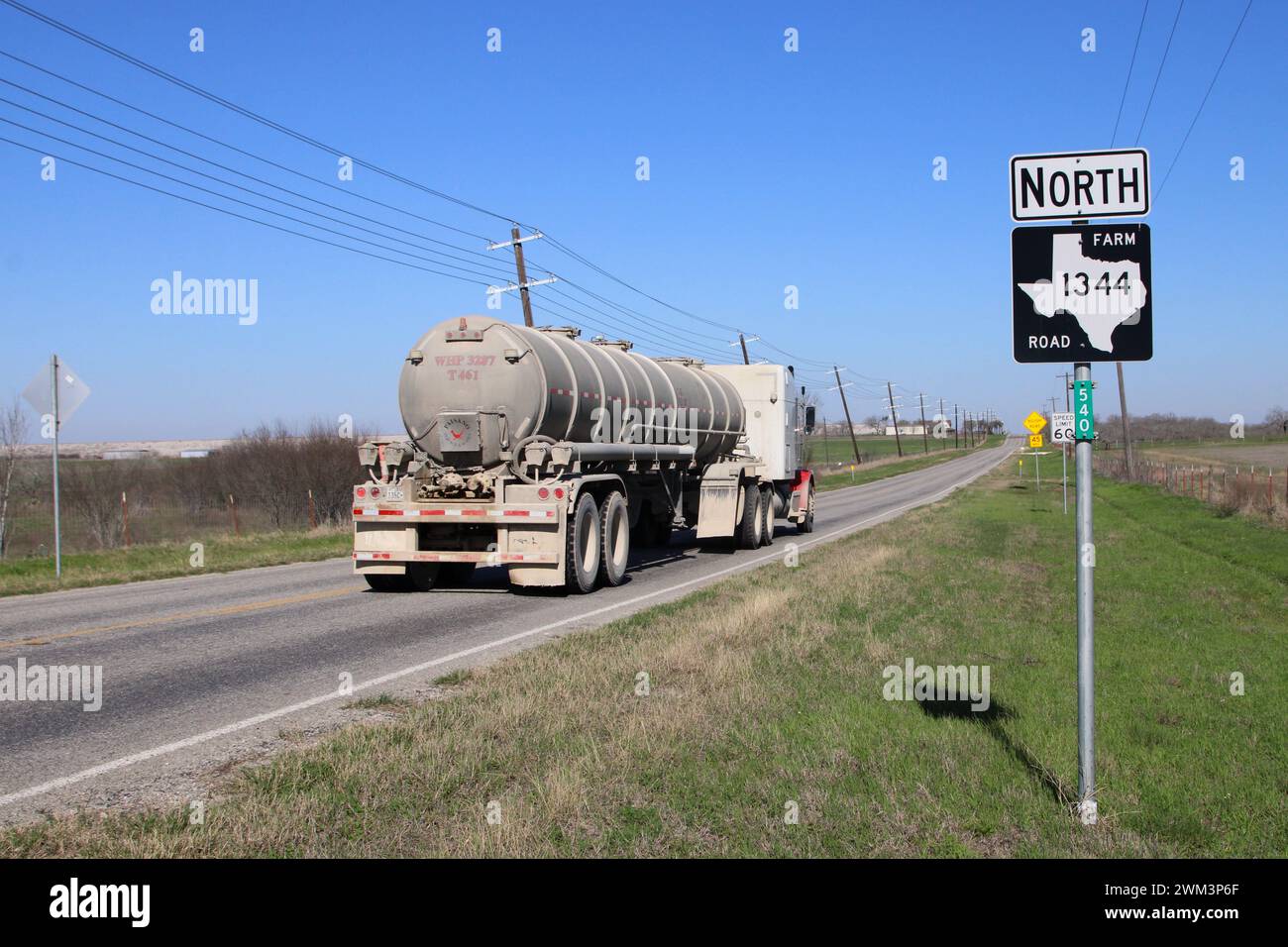 An oil field tank truck heads north on a Farm to Market road near the town of Falls City, Texas, USA, on February 23, 2024. Falls City and the surrounding Karnes County is one of 30 counties that make up the area known as the Eagle Ford Shale oil and gas production area. Recently the area around Falls City has been experiencing an increase in seismic activity, including 23 earthquakes since February 11, 2024. Experts have tied many earthquakes in Texas to the oil and gas extraction process known as fracking. (Photo by Carlos Kosienski/Sipa USA) Stock Photo