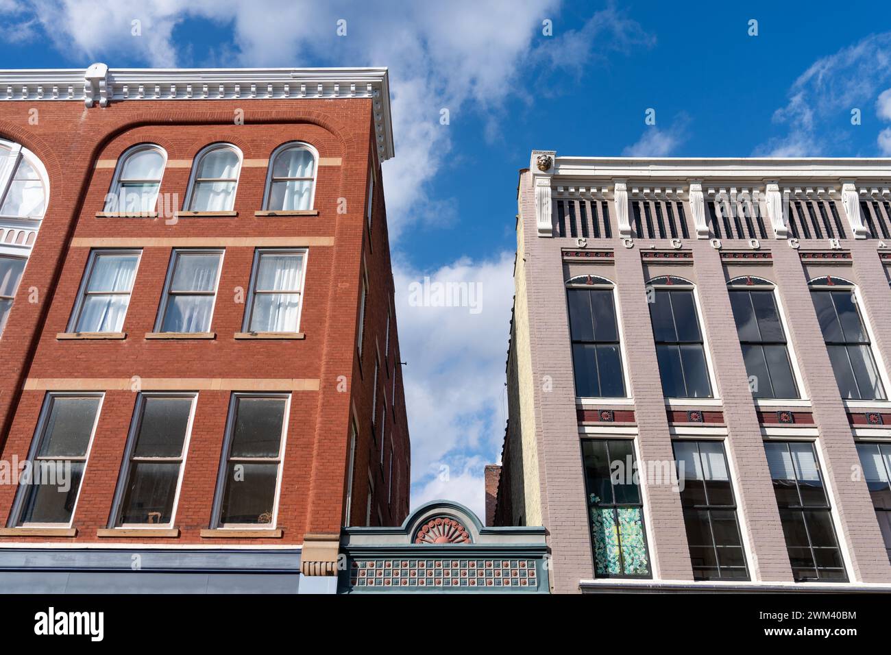 Downtown Staunton, Virginia buildings with significant architectural details against blue sky. There is a gap between the buildings. Stock Photo