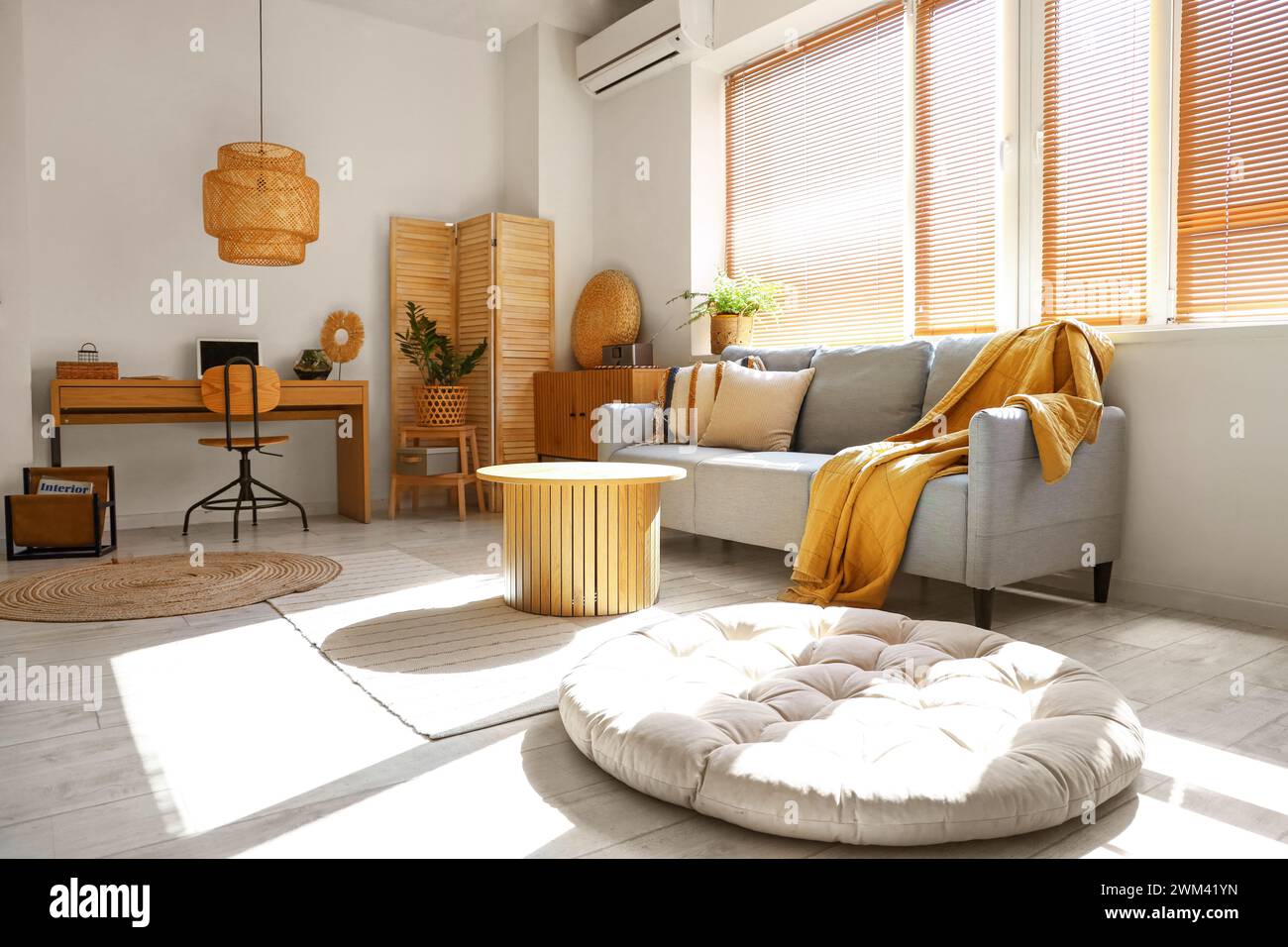 Interior of stylish living room with grey sofa and workplace Stock ...