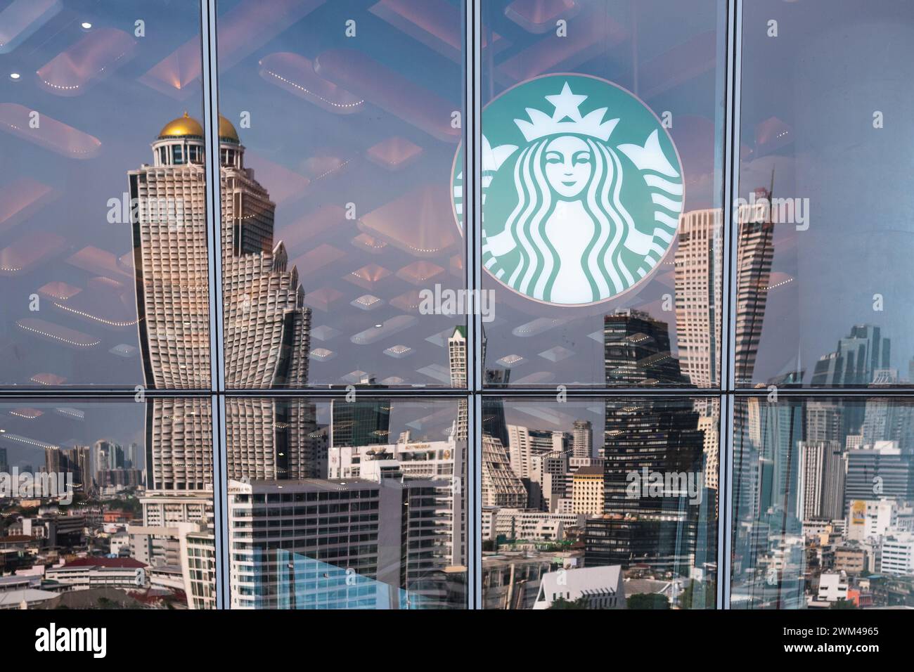 Logo of Starbucks with the reflection of the downtown at Starbucks at Iconsiam shopping mall on September 2, 2023, in Bangkok, Thailand. Stock Photo