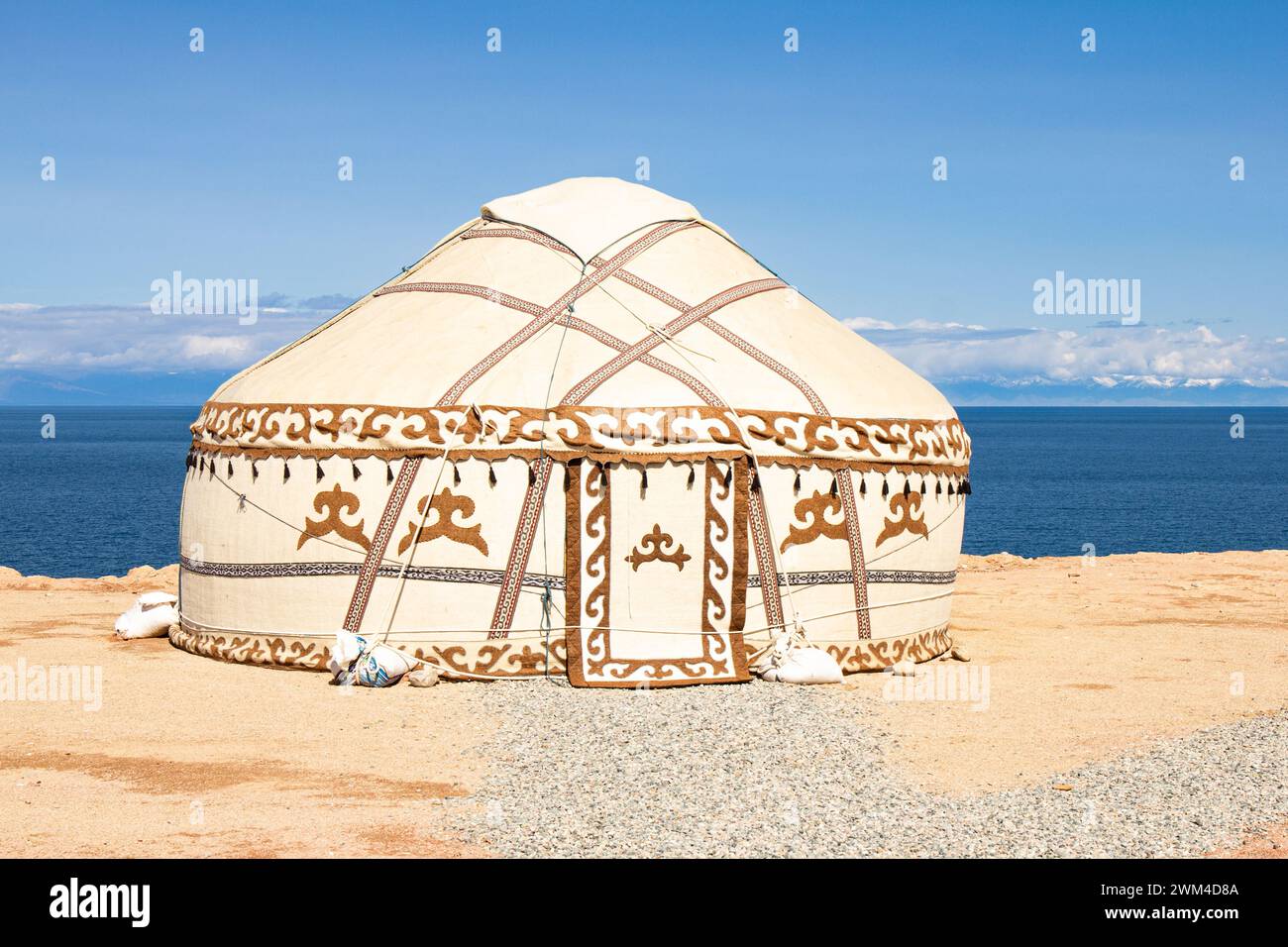 Traditional Yurt. National nomadic old house of Central Asia with blue sky on background. Issyk Kul high alpine lake in the Tian Shan Mountains. Kyrgy Stock Photo