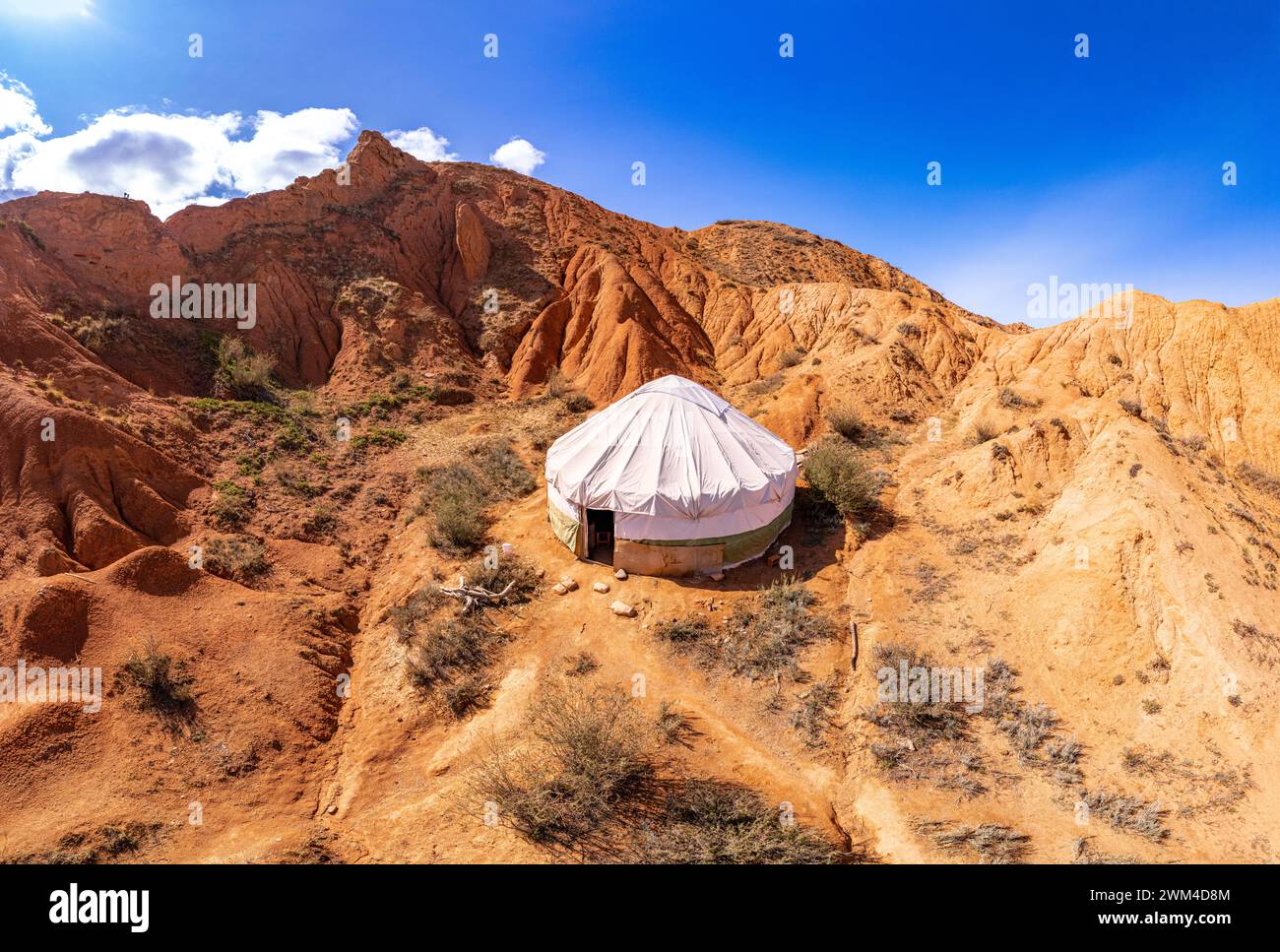 Traditional Yurt. National nomadic old house of Central Asia in fairy Tale Canyon also Skazka. Red rock formations of sandstone nearby the Issyk-Kul l Stock Photo