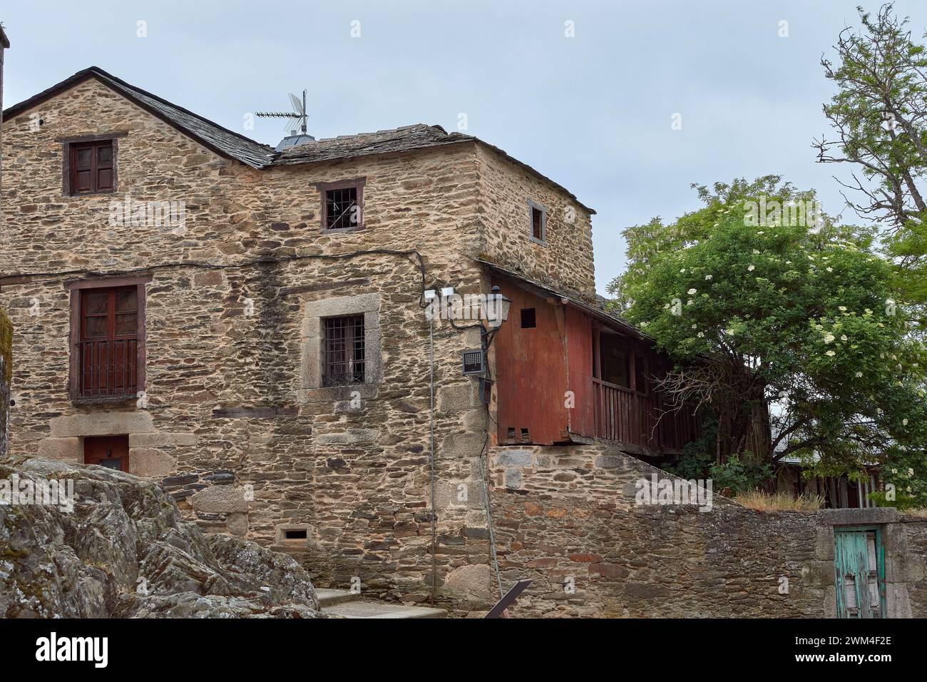 Old village with picturesque stone buildings and flowers in Puebla de Sanabria, Zamora province, Castilla y León, Spain Stock Photo