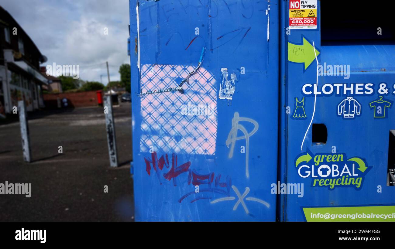 Street furniture, clothes skip with graffiti, global recycling, street ...