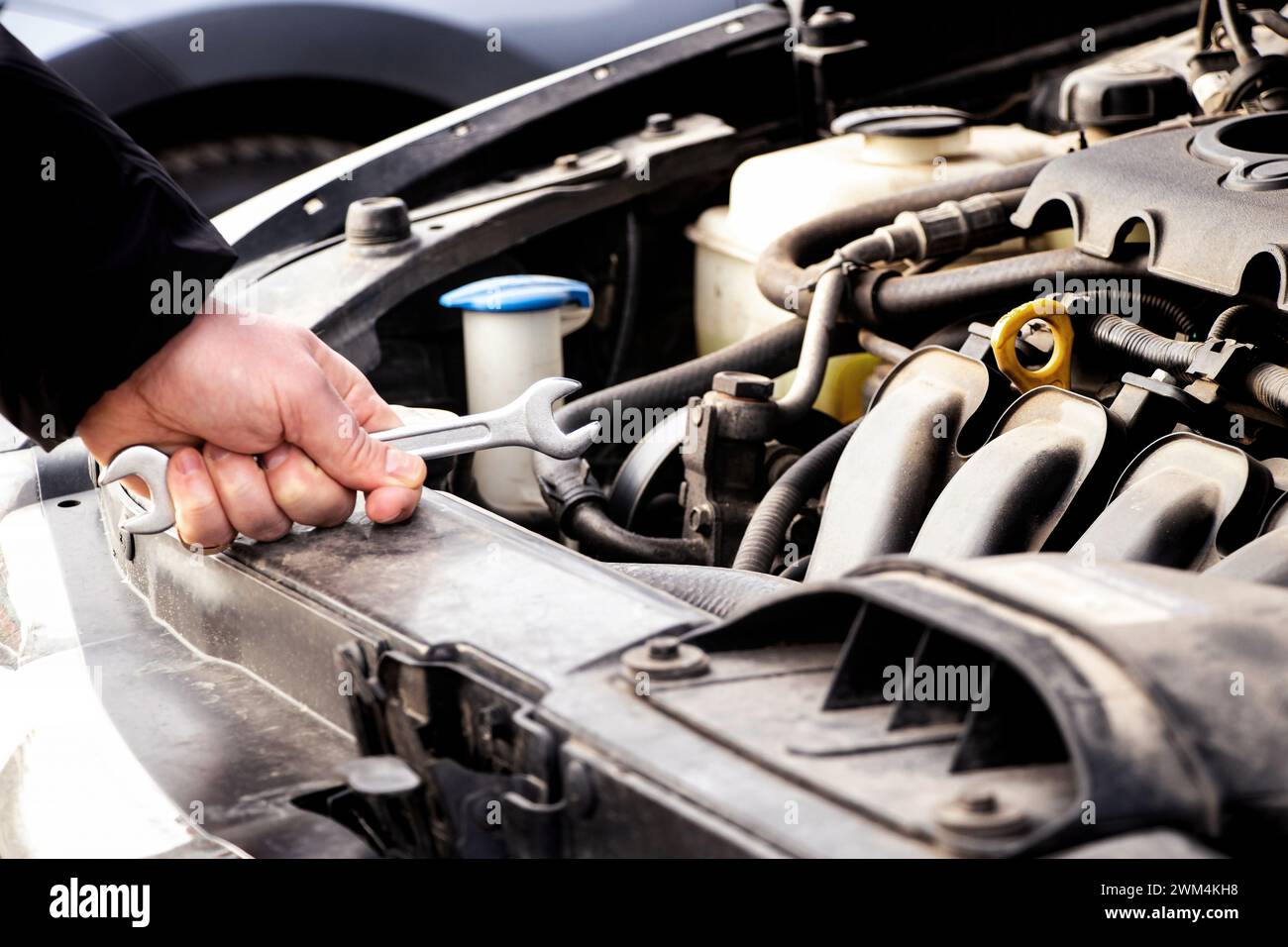Car care, maintenance and repair, auto mechanic, hand and wrench for car repair, engine problem and diagnosis, car repair Stock Photo