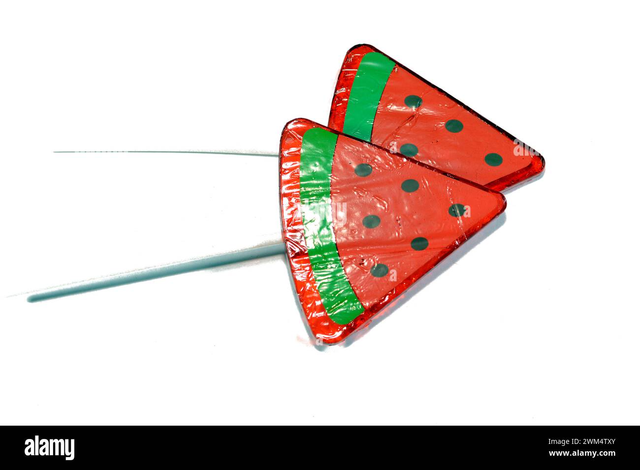 Watermelon flavored lollipop, a type of sugar candy usually consisting of hard candy mounted on a stick and intended for sucking or licking, lolly, su Stock Photo