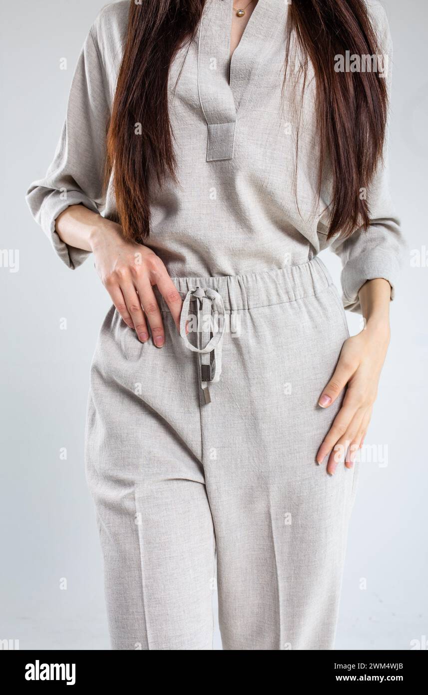 Model in elegant linen pantsuit, perfect for casual or smart-casual office looks. Breathable, lightweight fabric ideal for warm weather. Available in Stock Photo