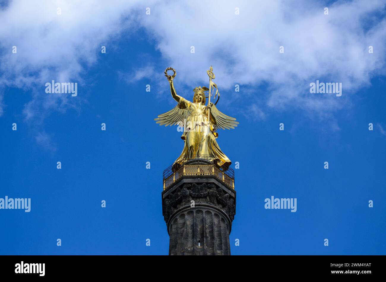 Siegessaule or Victory column with golden statue in Berlin, Germany. Clouds passing behind monument. Major tourist spot and sight in city. Stock Photo