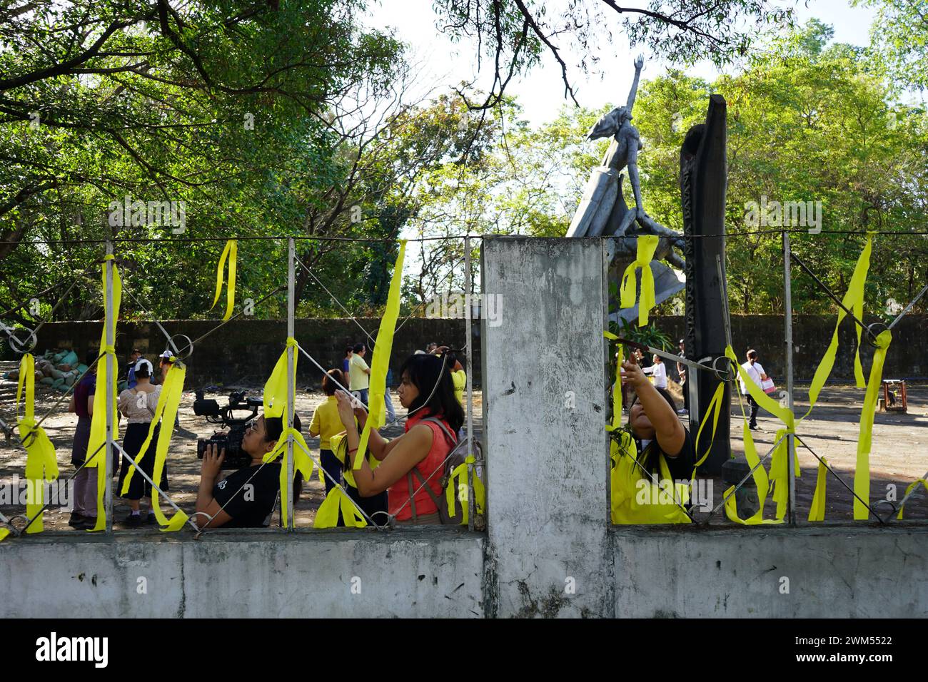 Quezon City, Philippines. 24th February 2024. Victims of human rights violation during the Martial Law and human rights advocates make ties with yellow ribbons around Bantayog ng mga Bayani during the weeklong celebration of the 38th EDSA People Power Revolution Anniversary on February 24, 2024 in Quezon City, Philippines. The initiative aims to celebrate the historic victory of the Pilipino people and reaffirm the democratic legacy of EDSA Revolution.(Credit Image: © Sherbien Dacalanio/Alamy Live News) Stock Photo