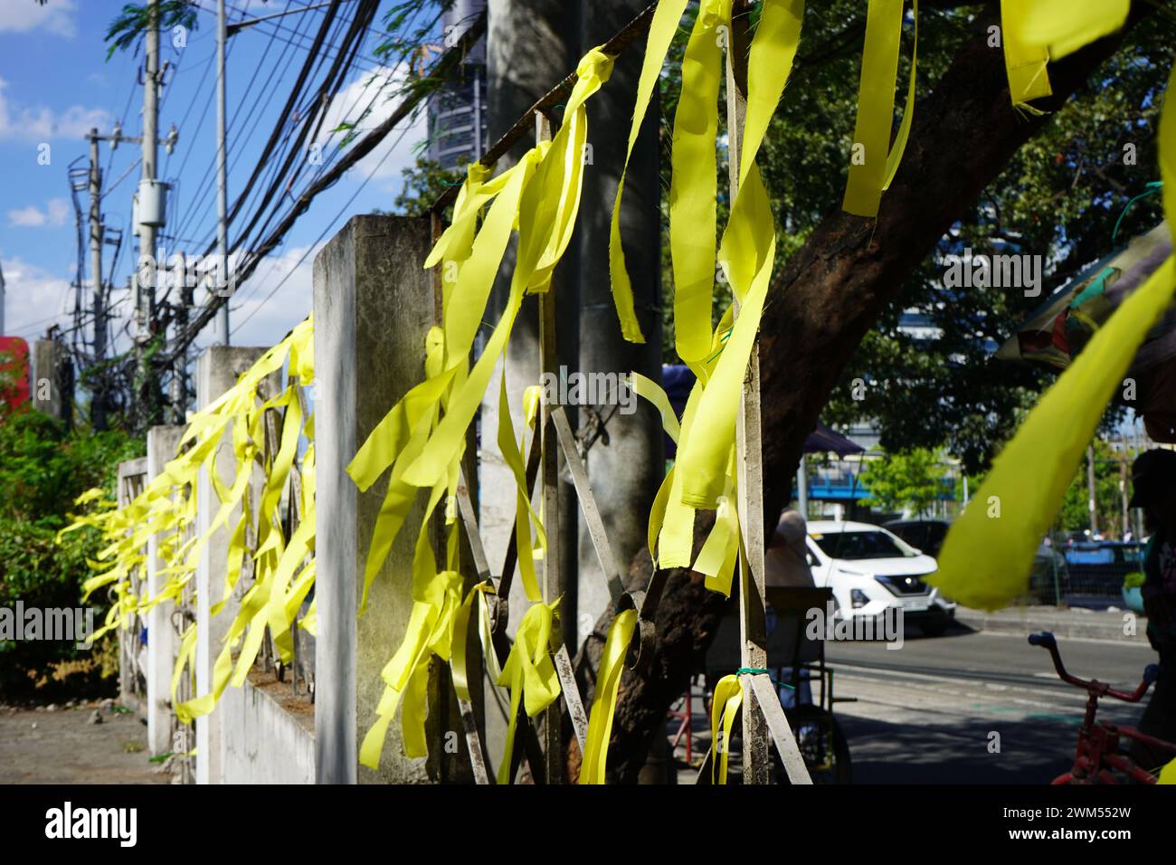 Quezon City, Philippines. 24th February 2024. Victims of human rights violation during the Martial Law and human rights advocates make ties with yellow ribbons around Bantayog ng mga Bayani during the weeklong celebration of the 38th EDSA People Power Revolution Anniversary on February 24, 2024 in Quezon City, Philippines. The initiative aims to celebrate the historic victory of the Pilipino people and reaffirm the democratic legacy of EDSA Revolution.(Credit Image: © Sherbien Dacalanio/Alamy Live News) Stock Photo