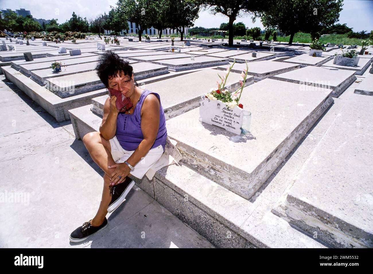 At the Cementerio Colon (Columbus Cemetery) in Havana, a mother mourns her son, who died in a traffic accident. Stock Photo