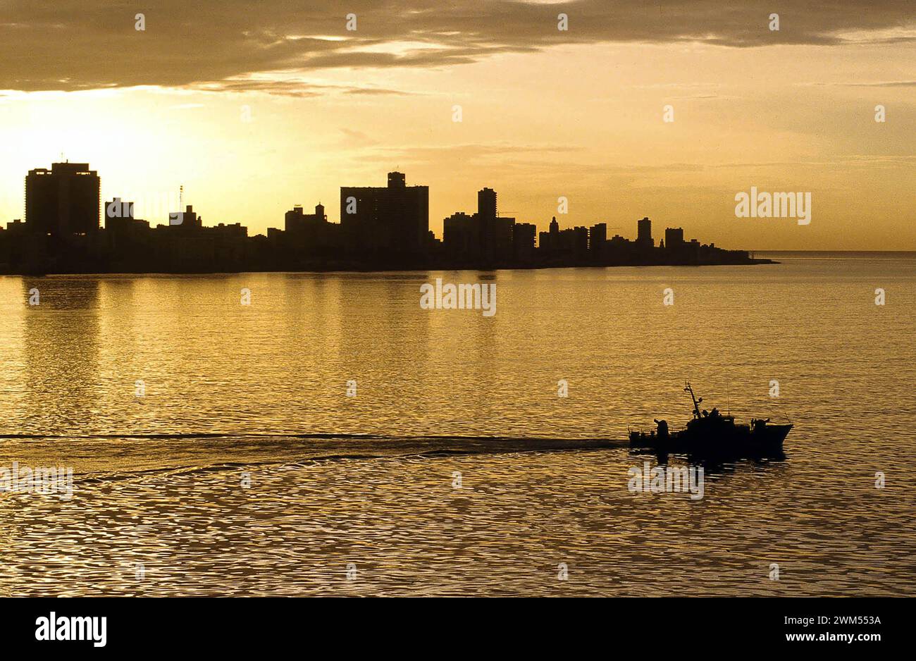 The evening falls over Cuba's capital Havana. A Coast Guard patrol boat leaves the harbour. Stock Photo