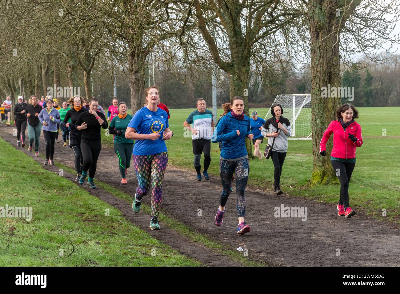 People taking part in Rushmoor Parkrun, a regular Saturday running event in Aldershot, Hampshire, England, UK, during February 2024. Women in sport. Stock Photo
