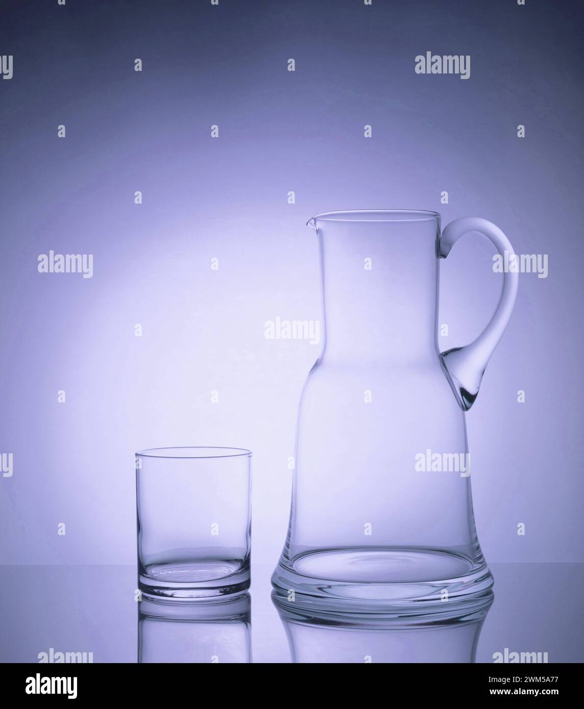 A stunning display of elegant glassware, illuminated by the glowing backlight and enhanced with helium filters, creating a mesmerizing and luxurious a Stock Photo