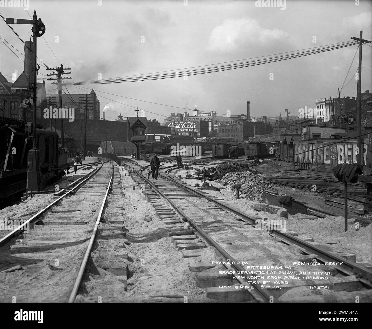 View of the Try Way freight yard, looking north from the Second Avenue crossing and showing the Allegheny County Courthouse and Jail on the left in the distance. Coca Cola sign, 1912 - Pittsburgh, Pennsylvania Stock Photo