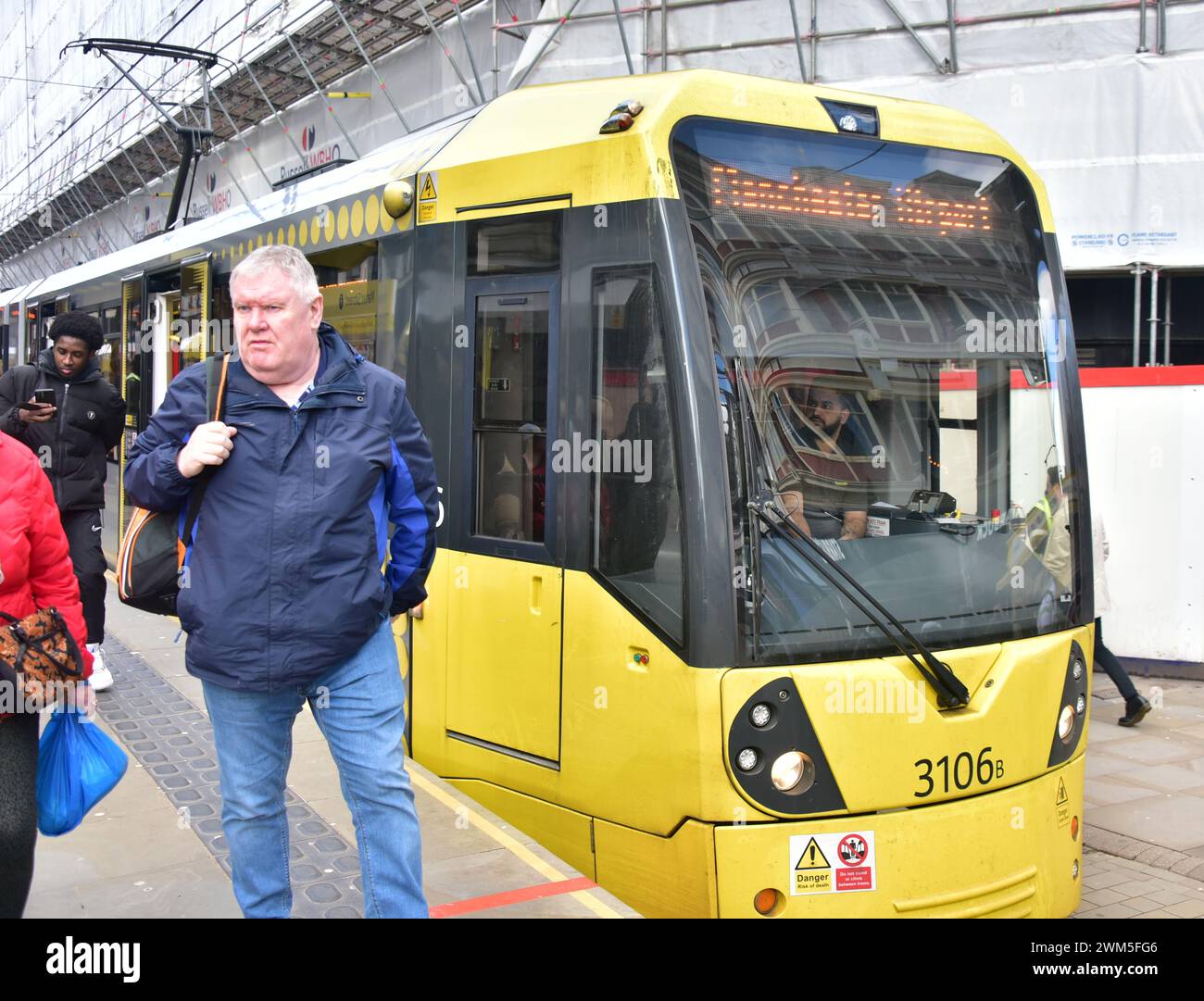 Passengers walk past a Manchester Metrolink tram at the Market Street ...