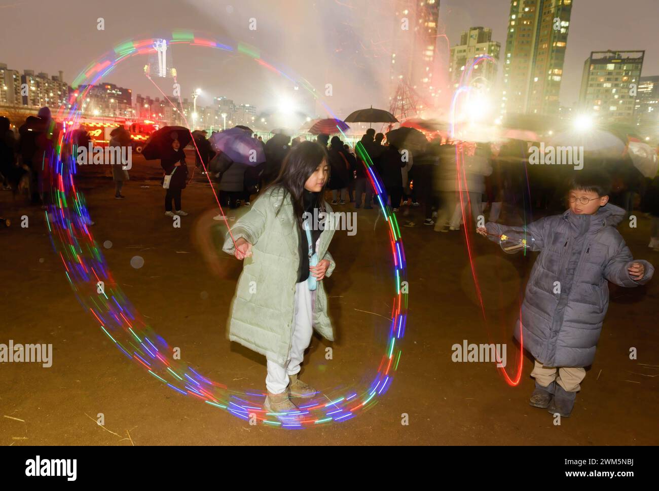 Seoul, South Korea. 24th Feb, 2024. Children spin LED lights during an event marking the Jeongwol Daeboreum (The Great Full Moon Festival) at a riverside park in Seoul. Jeongwol Daeboreum is a Korean holiday that celebrates the first full moon of the Korean lunar new year, which is mostly based on the lunisolar calendar. This festival is the Korean version of the Great Full Moon Festival. (Photo by Kim Jae-Hwan/SOPA Images/Sipa USA) Credit: Sipa USA/Alamy Live News Stock Photo