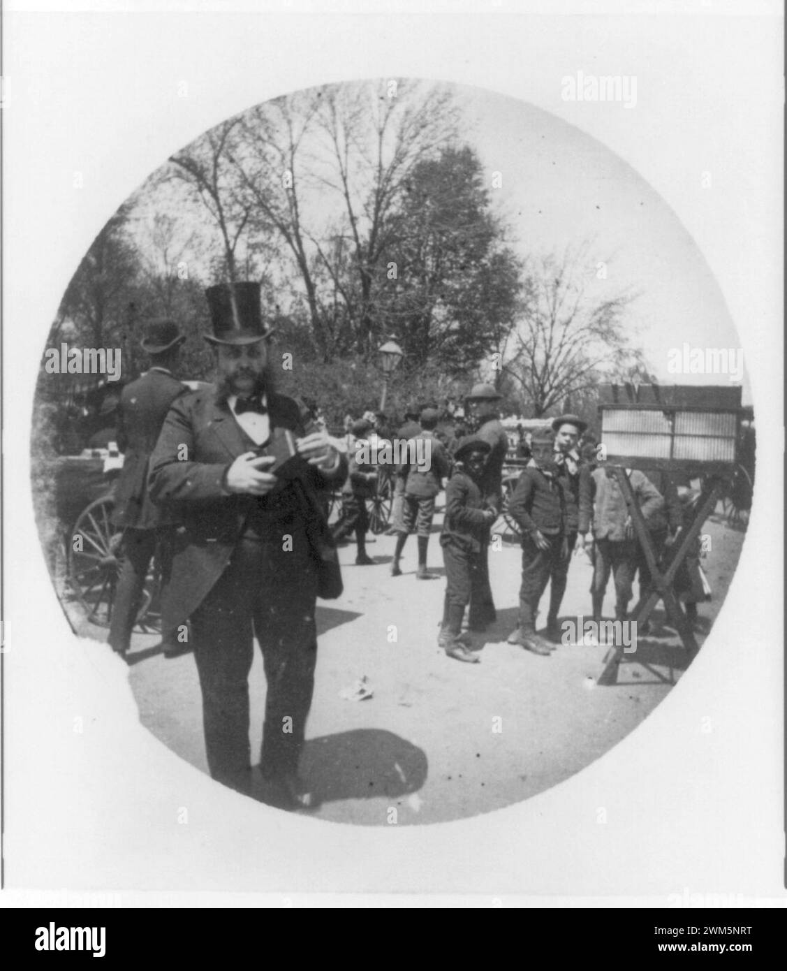 Bearded man in high hat carrying early Kodak camera Stock Photo