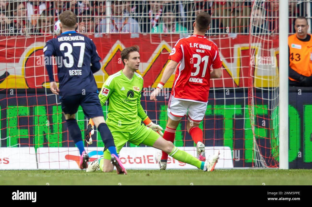 Berlin, Germany. 24th Feb, 2024. Soccer: Bundesliga, 1. FC Union Berlin - 1. FC Heidenheim, Matchday 23, An der Alten Försterei. Berlin goalkeeper Frederik Rönnow (M) concedes Heidenheim's goal to make it 1-0. Credit: Andreas Gora/dpa - IMPORTANT NOTE: In accordance with the regulations of the DFL German Football League and the DFB German Football Association, it is prohibited to utilize or have utilized photographs taken in the stadium and/or of the match in the form of sequential images and/or video-like photo series./dpa/Alamy Live News Stock Photo