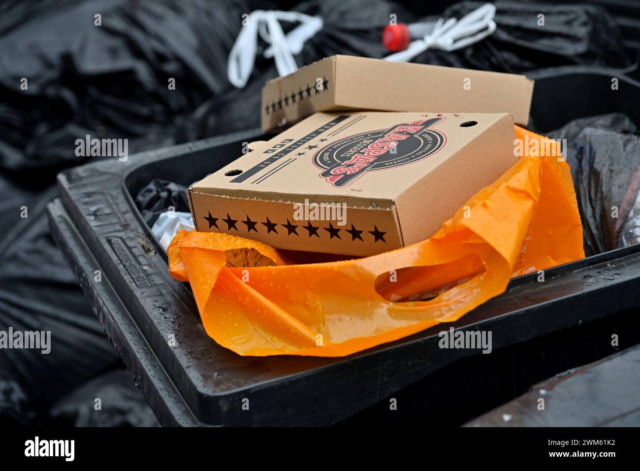 Overflowing waste bin with cardboard boxes and fly tipped rubbish, Bristol, UK Stock Photo