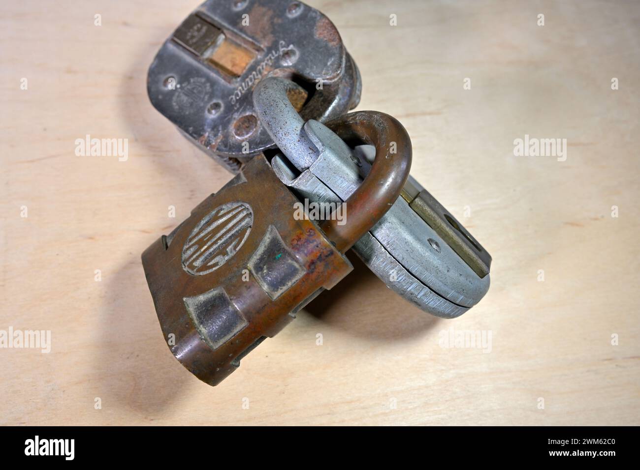 Three padlocks locked together Stock Photo