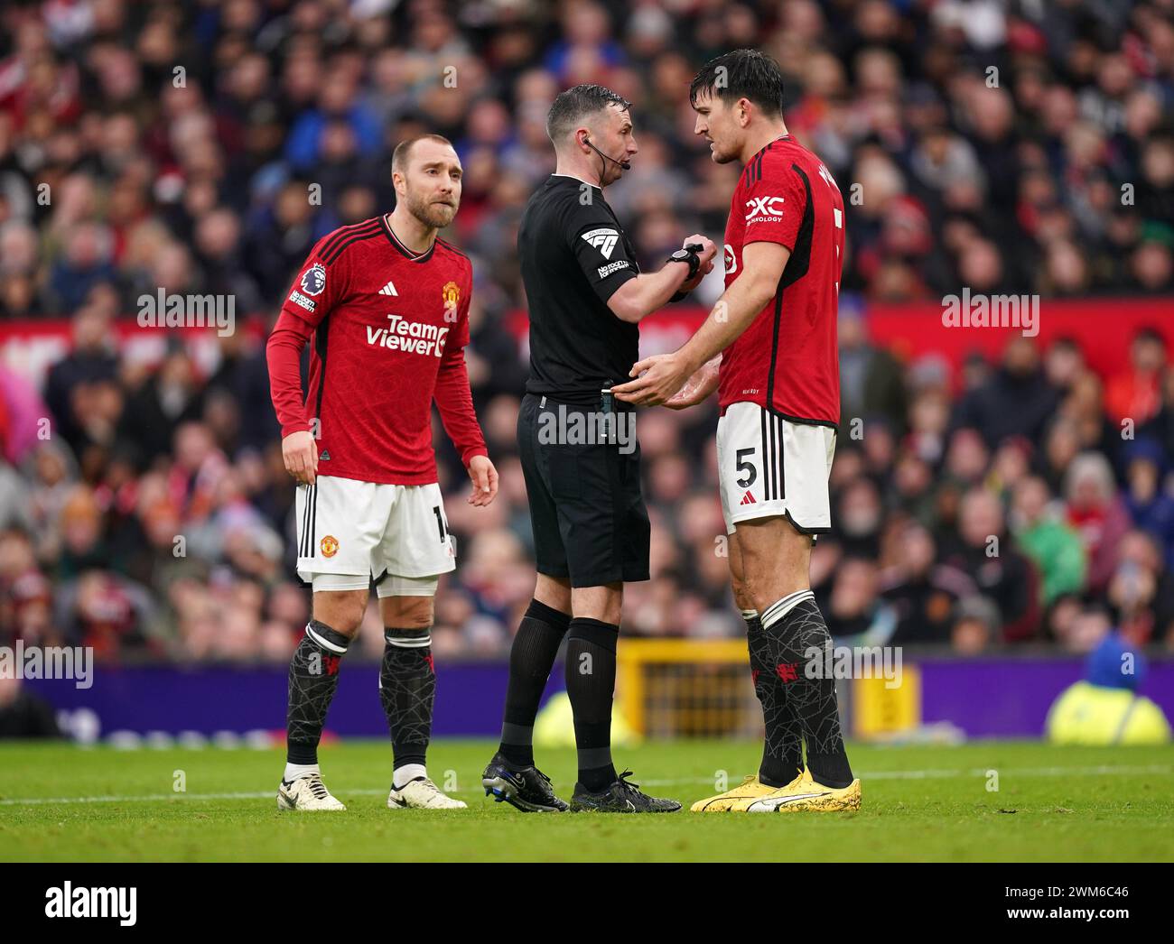 Referee Michael Oliver speaks to Manchester United's Harry Maguire during the Premier League match at Old Trafford, Manchester. Picture date: Saturday February 24, 2024. Stock Photo