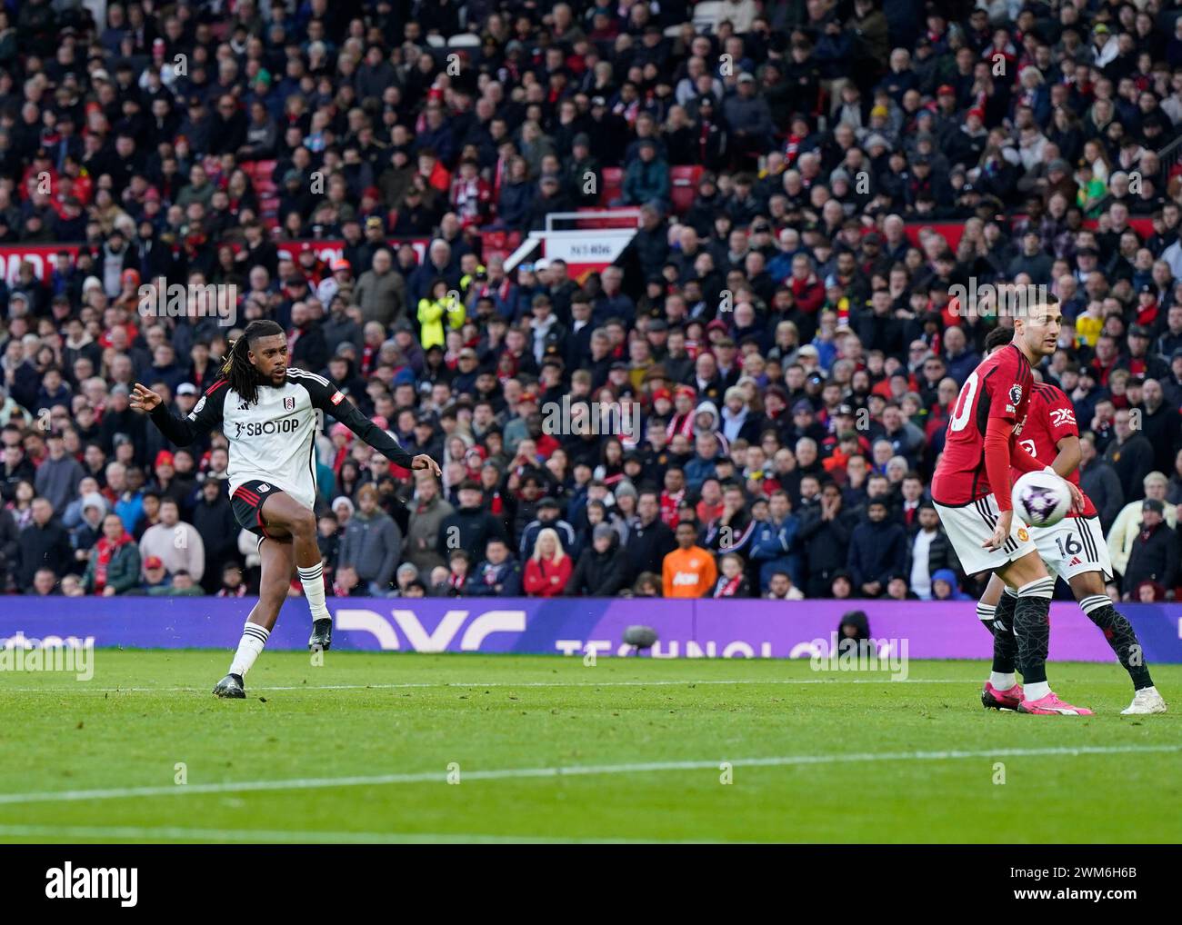 Manchester, UK. 24th Feb, 2024. Alex Iwobi of Fulham scoring their second goal during the Premier League match at Old Trafford, Manchester. Picture: Andrew Yates/Sportimage Credit: Sportimage Ltd/Alamy Live News Stock Photo